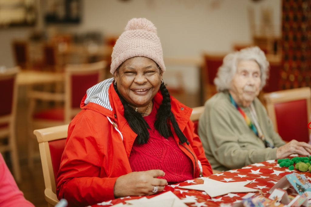 A woman sat at a table laughing.